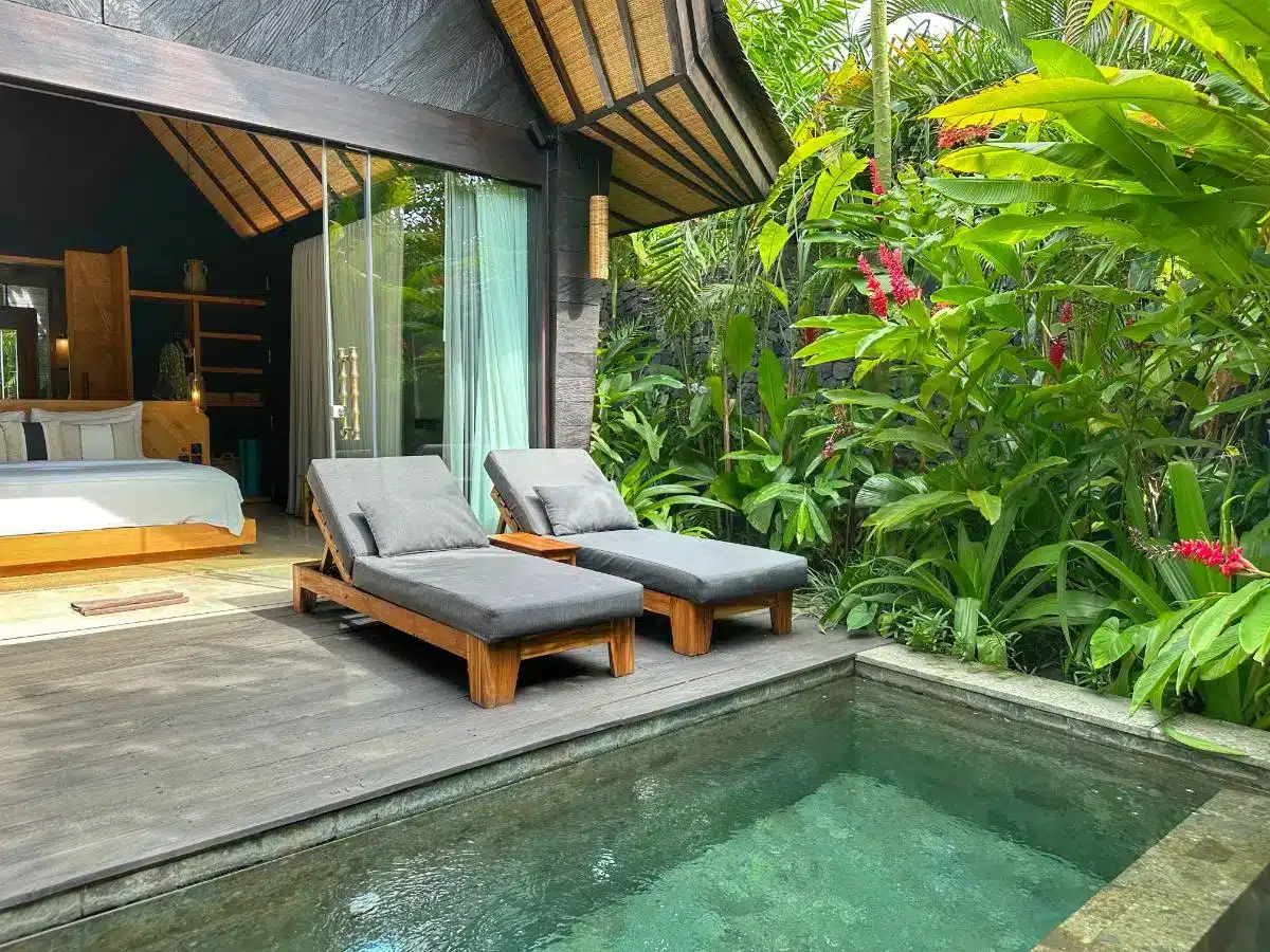 Private plunge pool with sunbeds on wooden deck terrace at the Premium Jabu Villa in Desa Hay Bali
