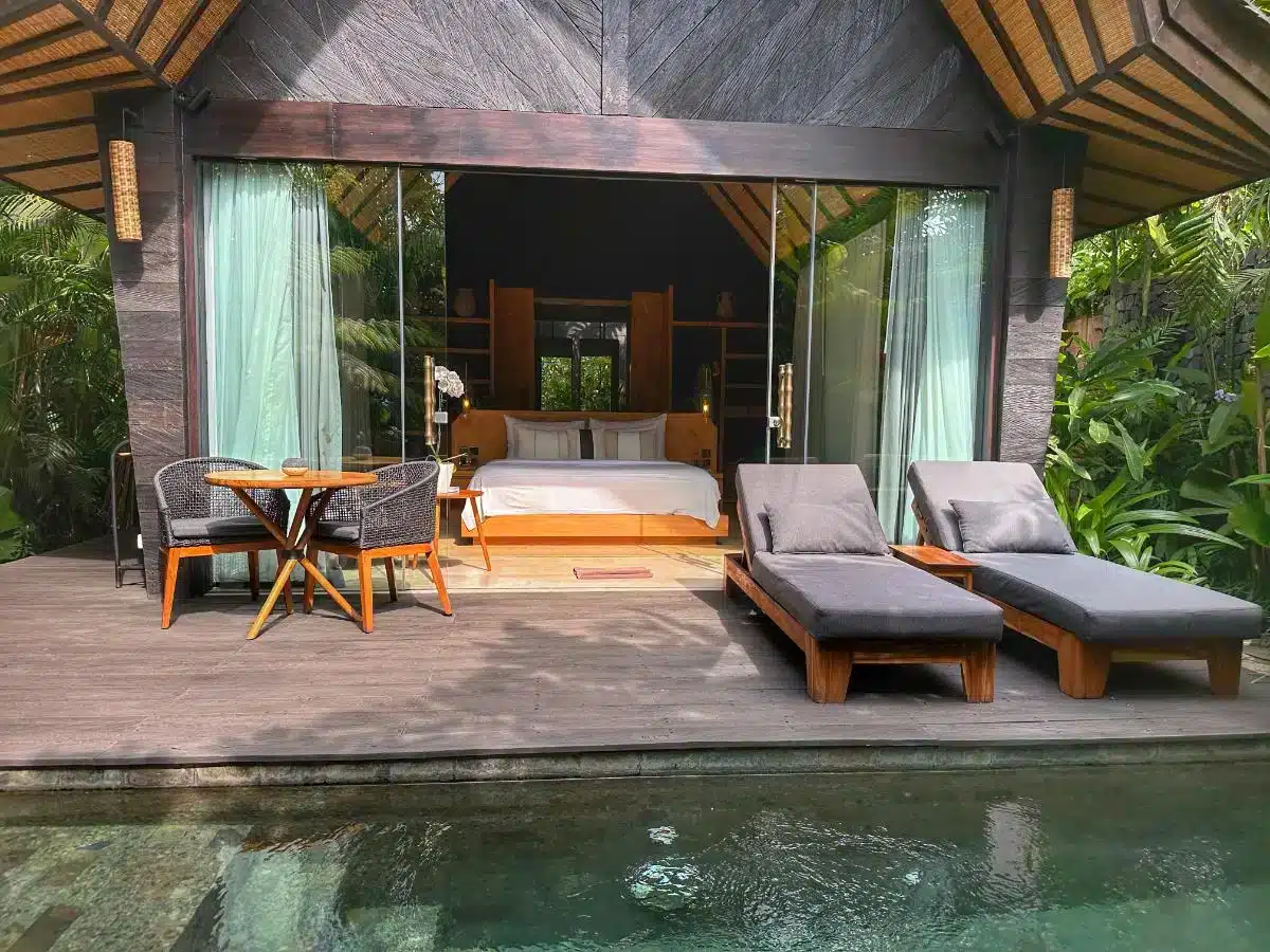 Villa exterior terrace with sunbeds and dining furniture in front of the Premium Jabu Villa entrance at Desa Hay Bali