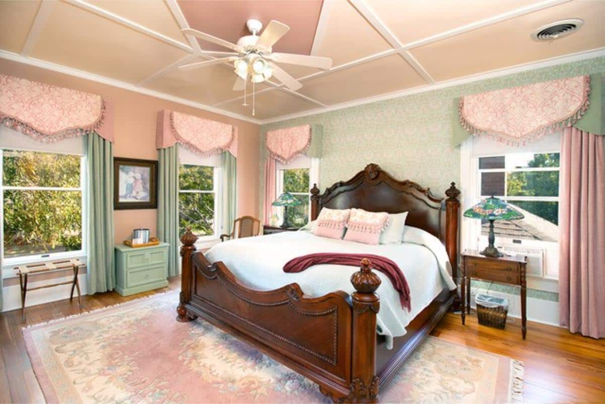 Bedroom with controlled natural light through adjustable blinds