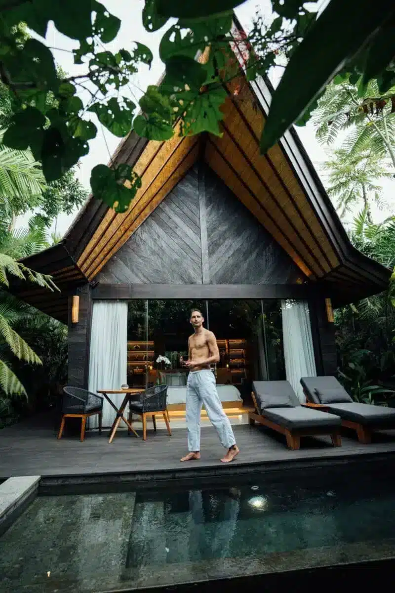 Premium Jabu Villa exterior at night showing the thatched roof warm interior lighting and wooden architecture at Desa Hay Bali