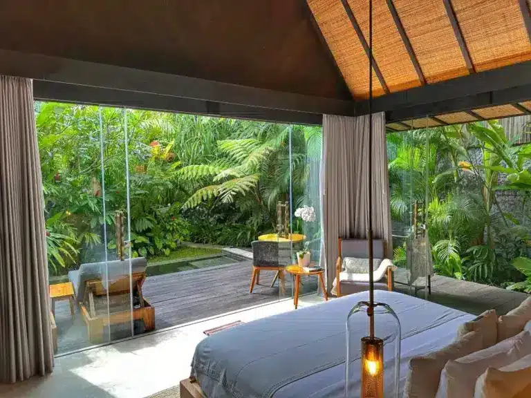 Elegant bedroom with white linens and wooden beams at Desa Hay Bali
