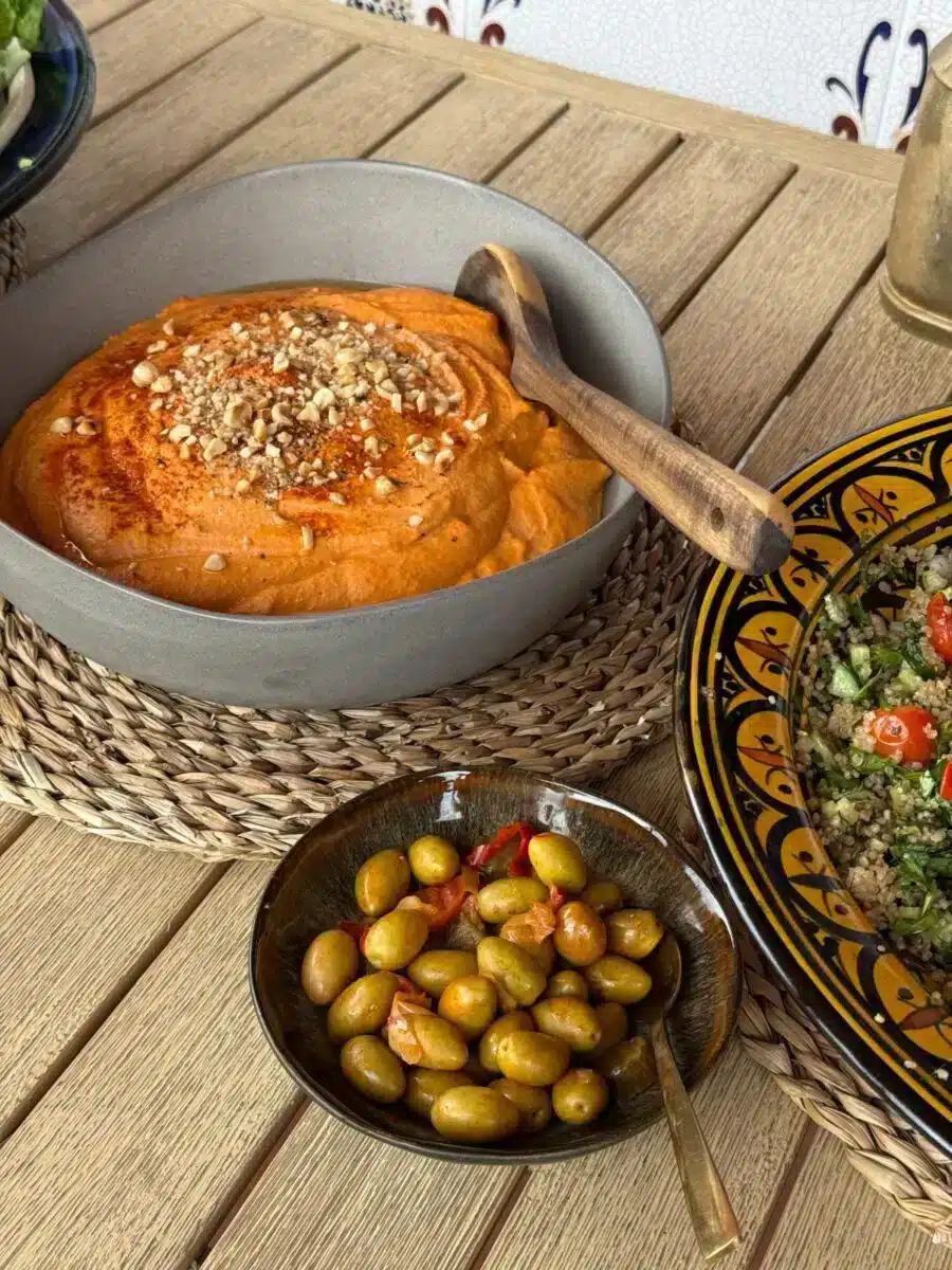 Fresh artisan bread olives and traditional Mediterranean dishes on a wooden table at Costa del Soul retreat Málaga