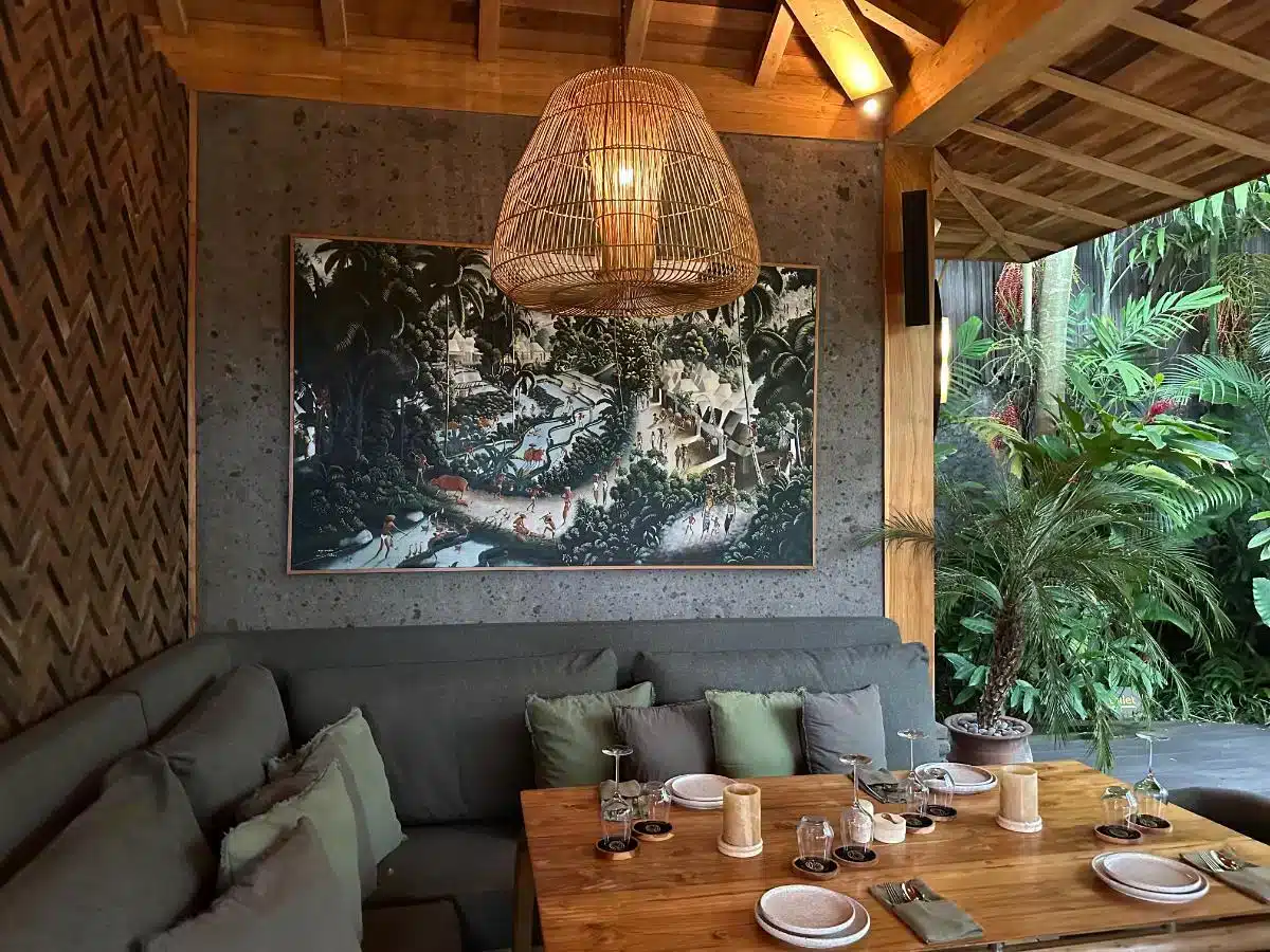 Ijo restaurant interior at Desa Hay Bali with woven bamboo ceiling comfortable seating and tropical artwork