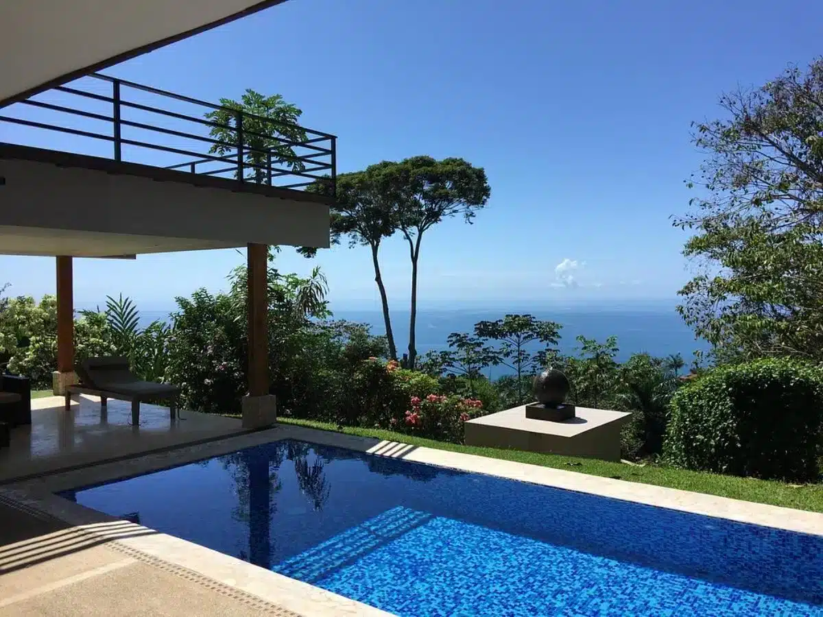 Infinity pool with panoramic Pacific Ocean views and tropical vegetation at Soul Alive Retreats Costa Rica