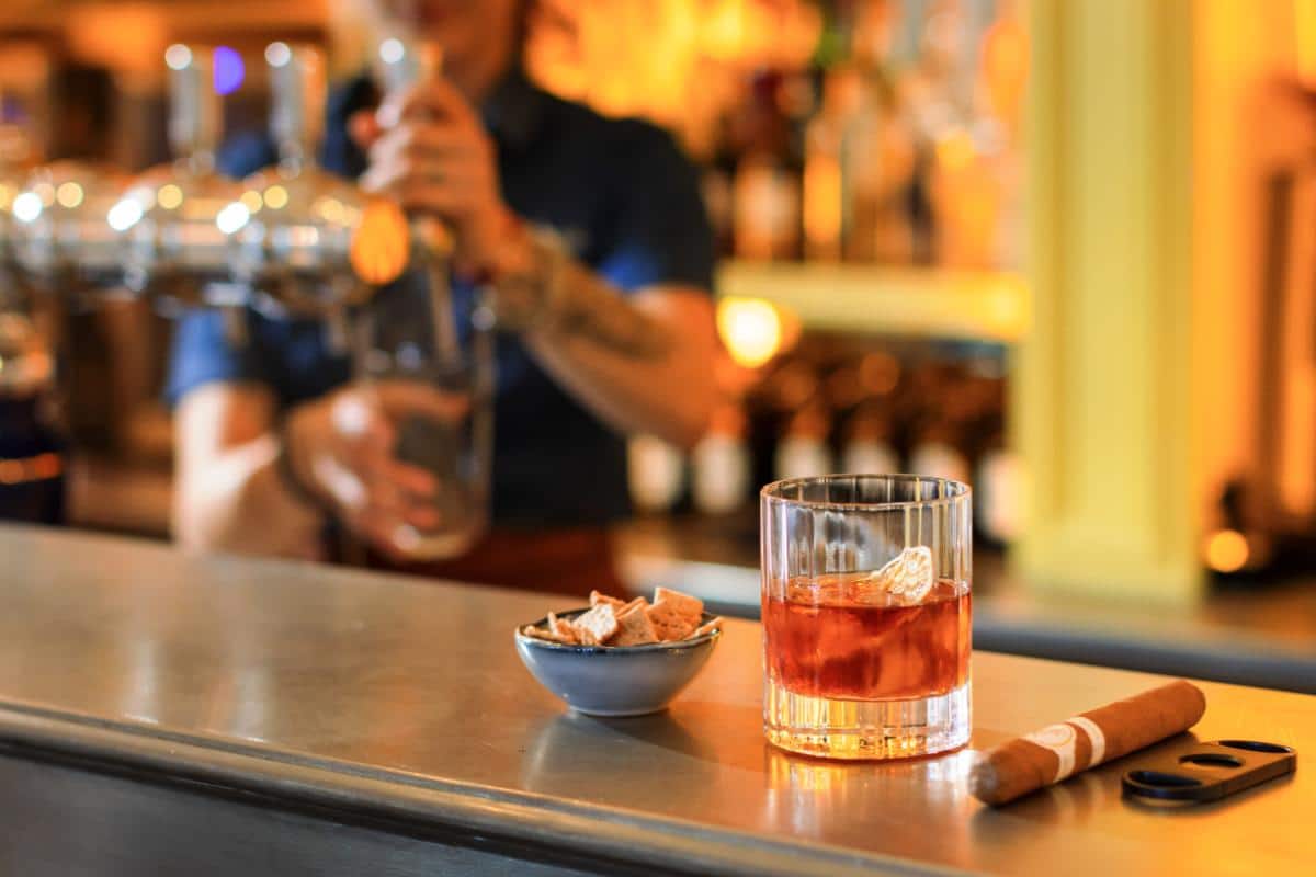 Cigar and Negroni cocktail on the bar terrace in warm evening light at Lou Calen Cotignac