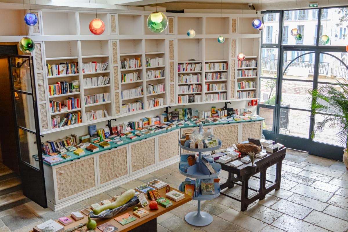Library at Lou Calen with tall bookshelves colorful books decorative globes and cozy reading nook