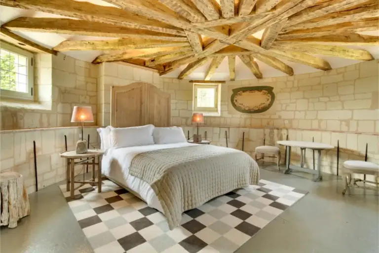 Elegant guest room with exposed stone at Chateau de Candes