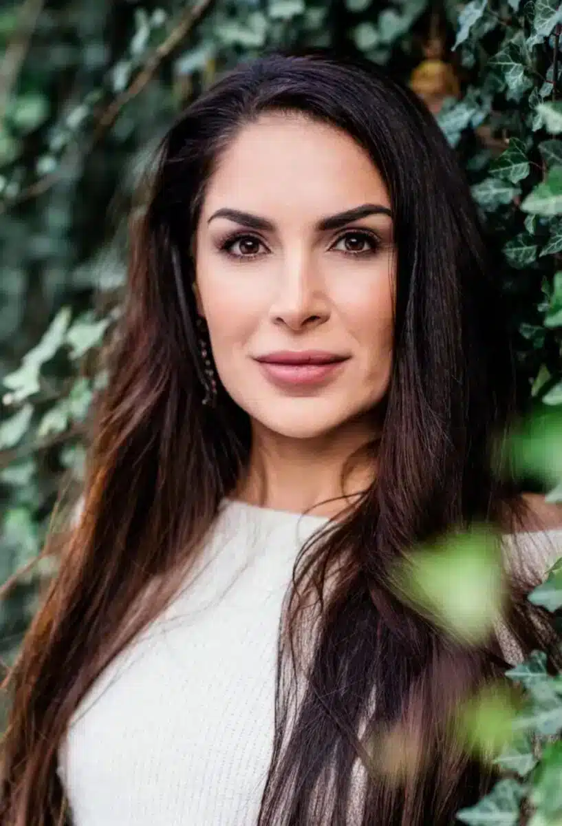 Portrait of Sayé Yabandeh founder of Sacred Ascension Journeys with natural green foliage in background