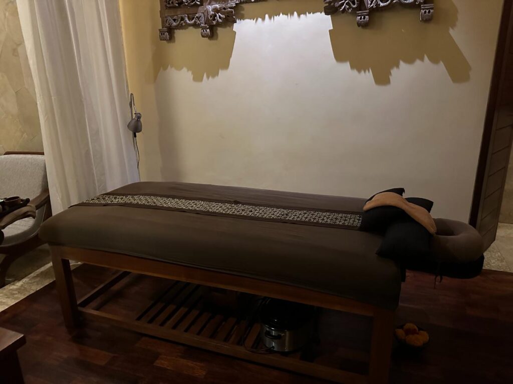 Spa consultation room at Munduk Moding Plantation Bali with Balinese carved decor, wooden desk and treatment tools