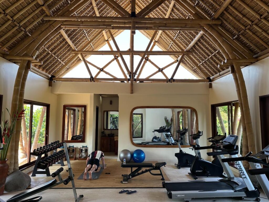 Munduk Moding Plantation Bali gym and fitness facilities interior with weights, mirrors and open jungle view windows