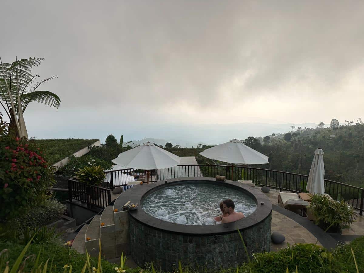 Expansive misty panoramic view of Munduk Moding Plantation Bali highlands with layers of tropical forest receding into cloud