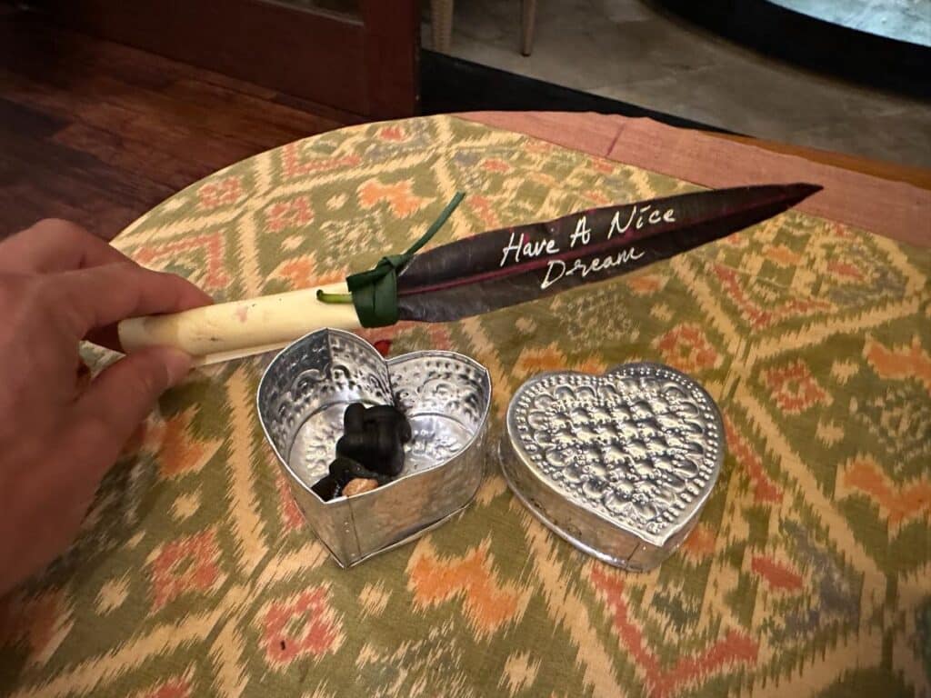 Personalised turndown gift at Munduk Moding Plantation Bali with handwritten 'Have A Nice Dream' message and silver heart-shaped trinket box