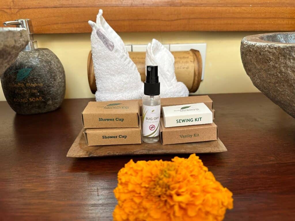 Bathroom vanity tray with Munduk Moding Plantation toiletries, Balinese marigold offering and handmade bamboo containers
