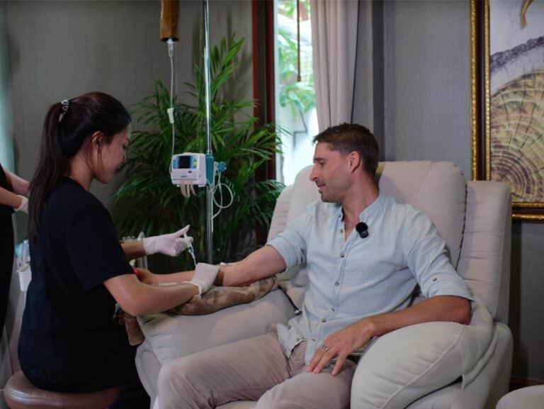 Tim Kroeger with Dr. Petch at Healthi Life Bangkok longevity program — biomarker testing and IV therapy documented