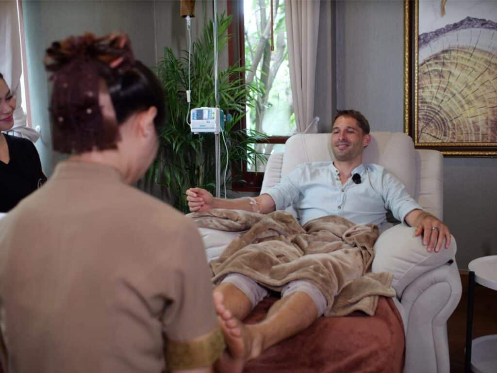 Foot massage during IV drip therapy at Healthi Life Bangkok longevity program — Session 1